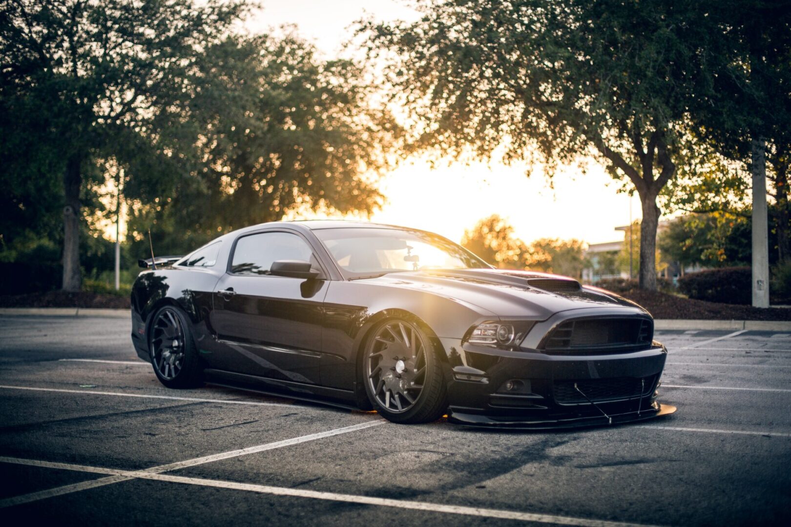 A black car parked in the parking lot