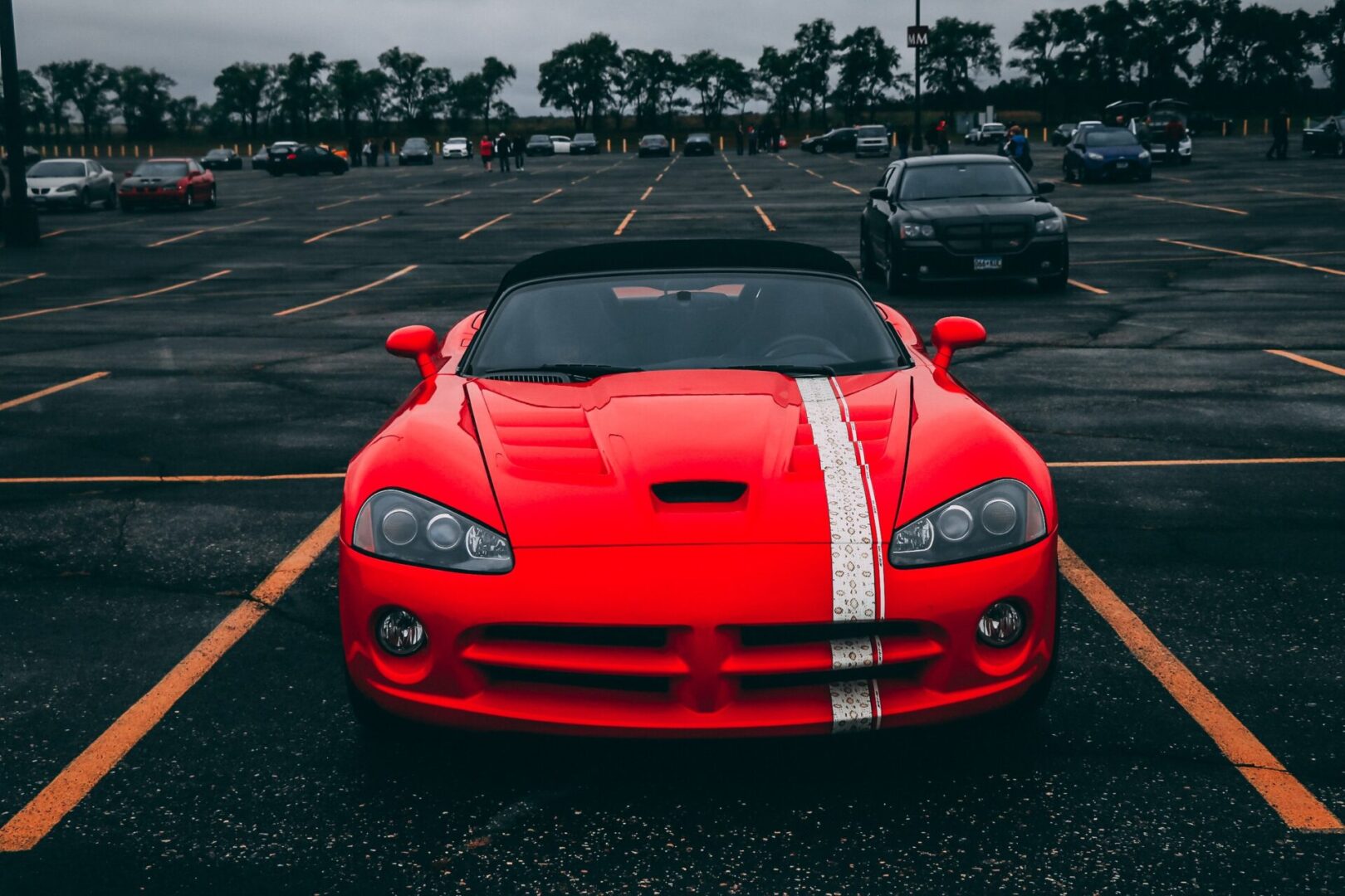 A red car parked in a parking lot.