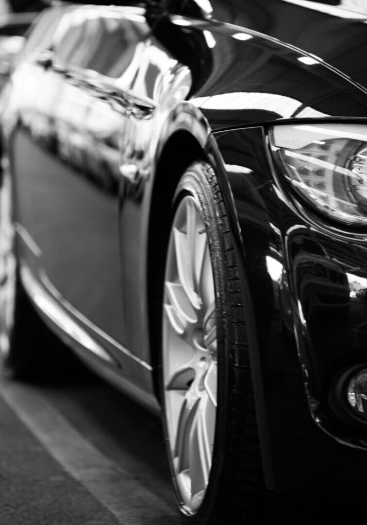 A black and white photo of some cars parked